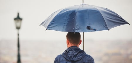 man standing under an umbrella