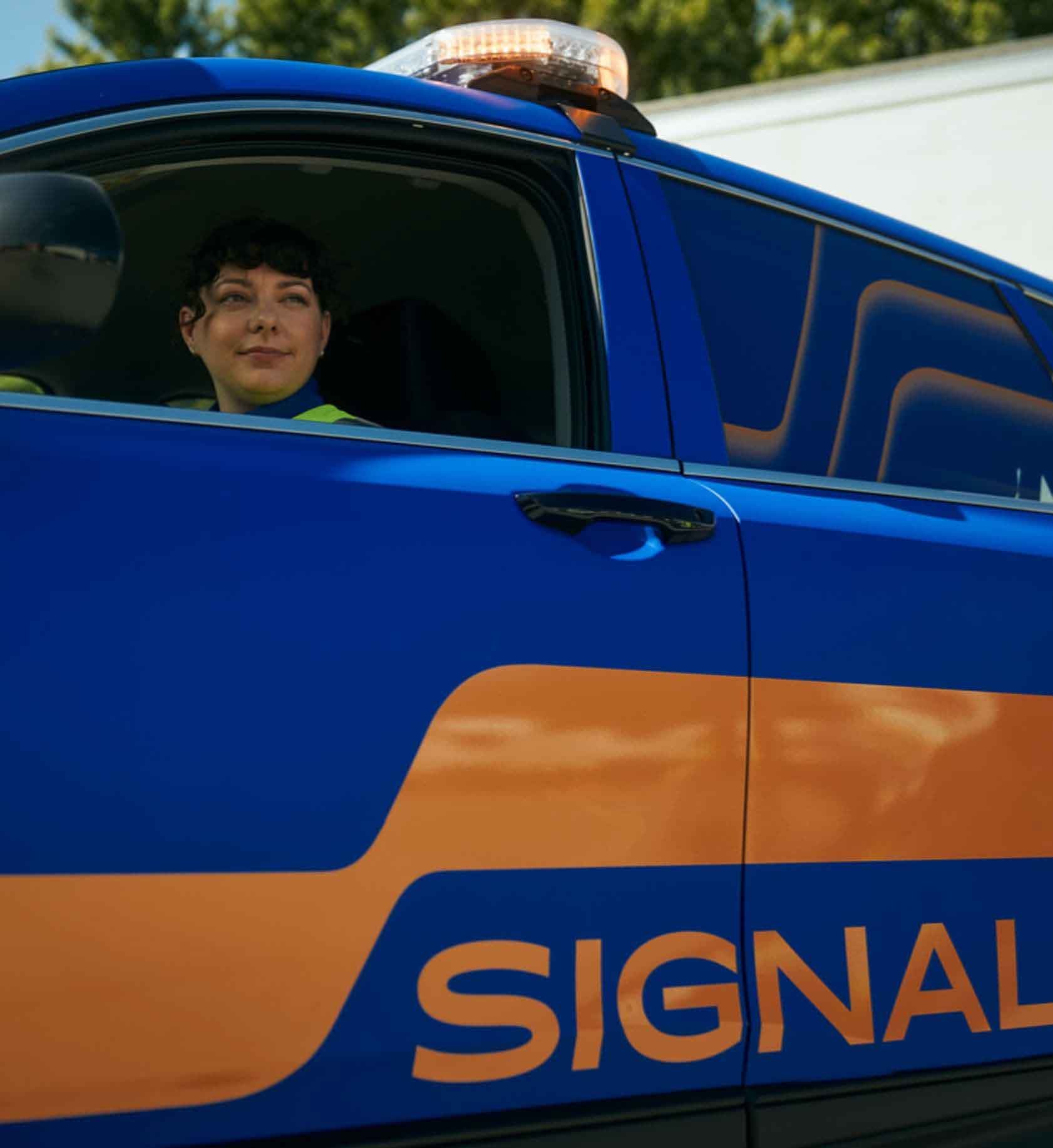 Signal employee inside of company vehicle