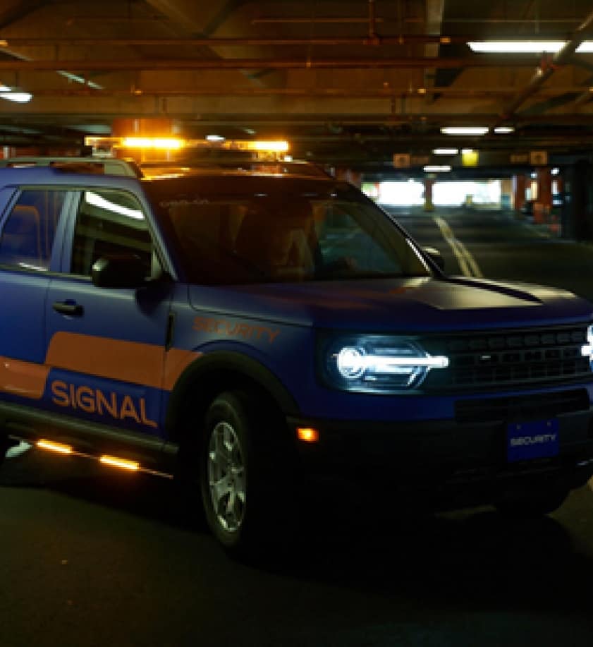 Signal company vehicle in a dark parking garage